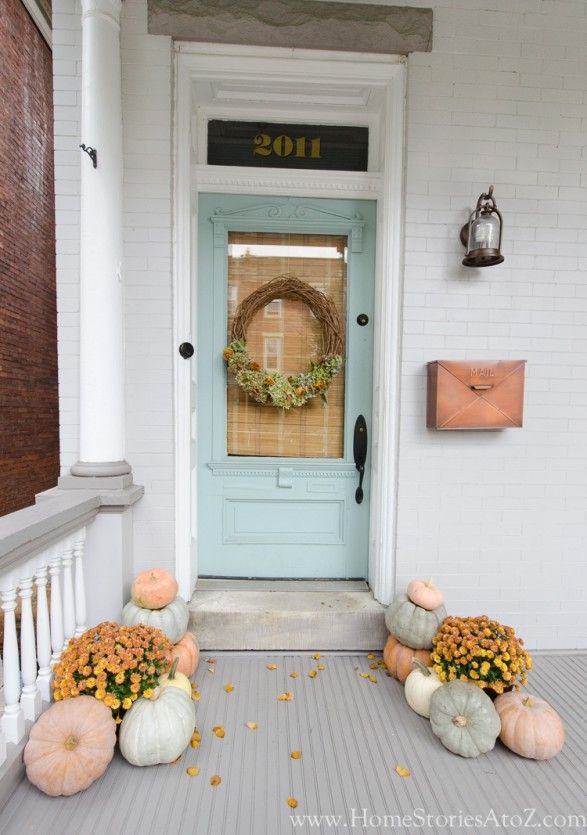 Fall front porch with faded pastel pumpkins via homestories