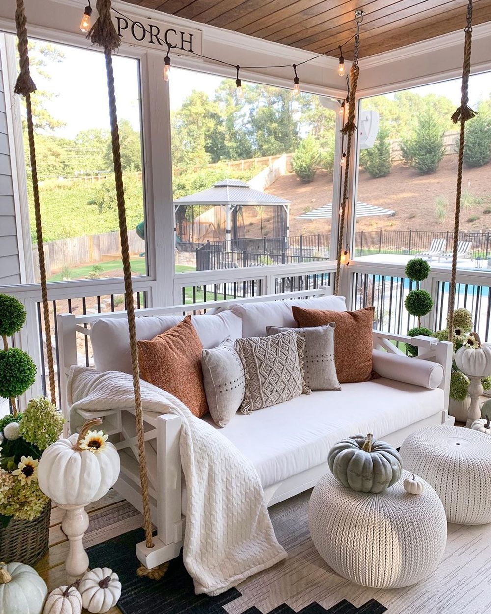 Fall front porch with rope swing with pillows via @mygeorgiahouse