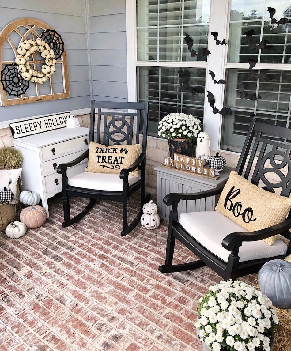 Halloween front porch decor with black rocking chairs and Boo pillows via @courtneyfitzp01