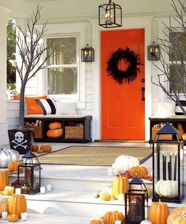 Halloween front porch decor with orange front door via infarrantlycreative