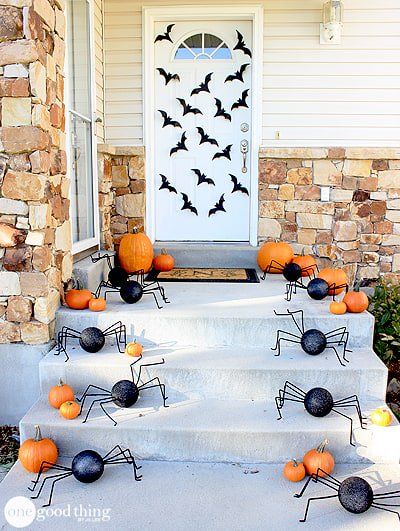 Halloween front porch decor with spiders on porch steps via onegoodthingbyjillee