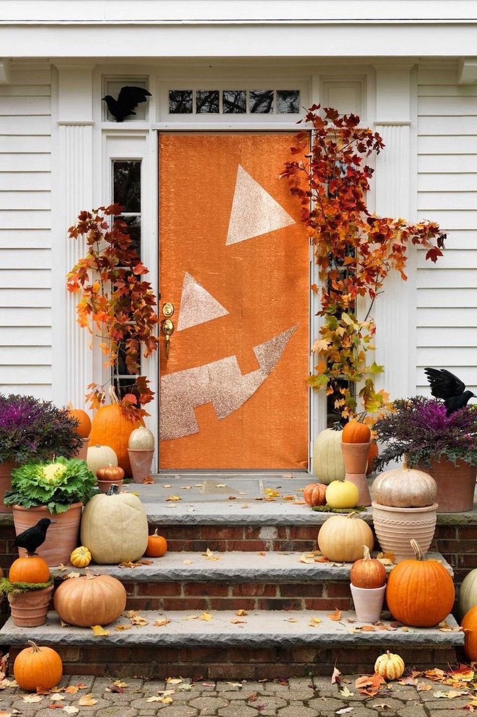 Halloween front porch decor with Pumpkin Face Door via womansday