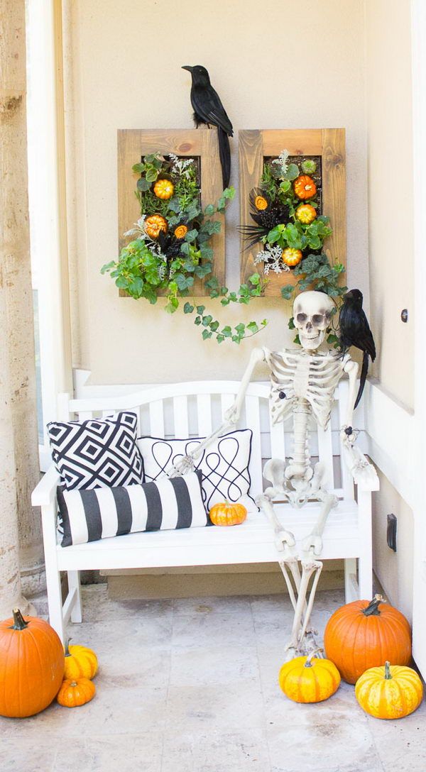 Halloween front porch decor with skeleton on bench