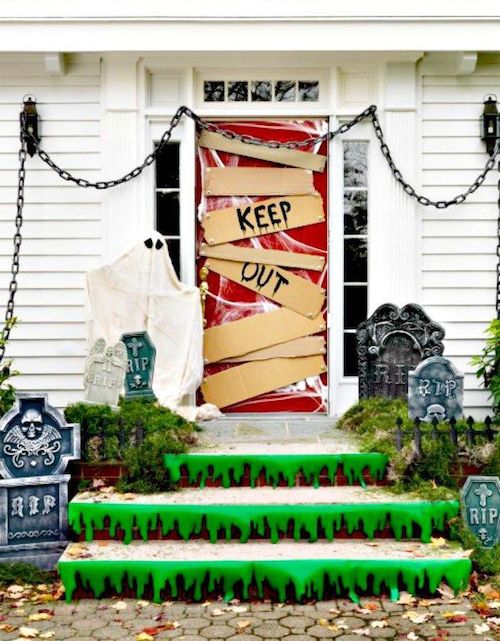 Keep out Halloween front door with green slime on steps and gravestones decor