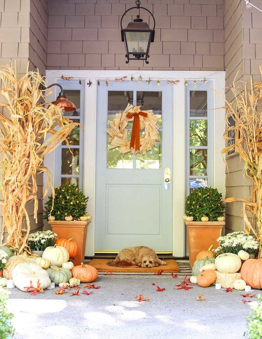 Neutral fall front porch with cornstalks via modern-glam