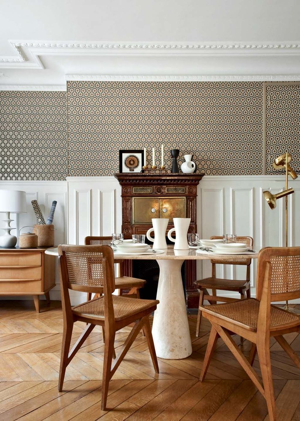 Parisian Dining room decor with neutral Cane back dining chairs via CoteMaison Emilie Bonaventure