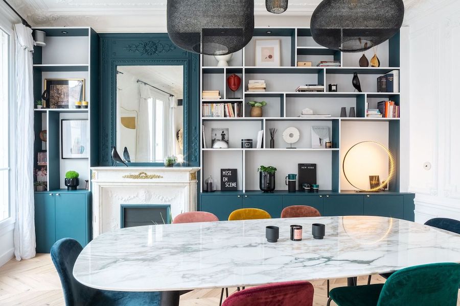 Parisian Dining room with turquoise bookshelf wall via Quitterie de Pascal