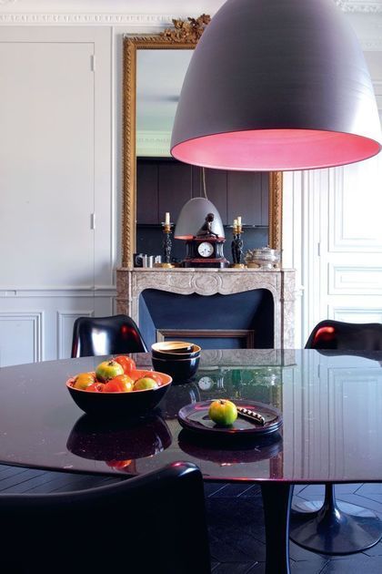 Parisian dining room with black table and chairs via CoteMaison