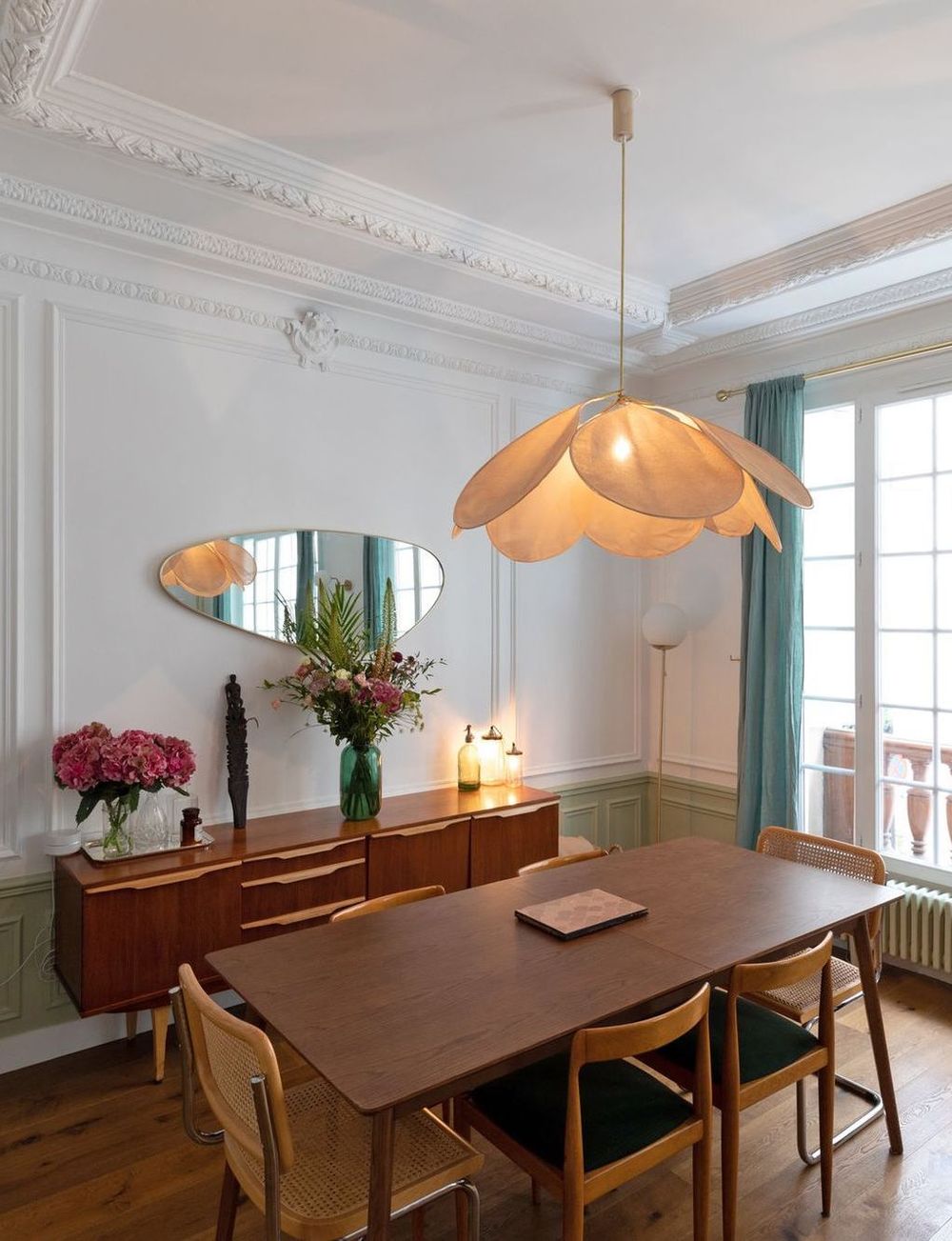 Parisian dining room with mid-century modern table, chairs and credenza via Charlotte Fequet CoteMaison