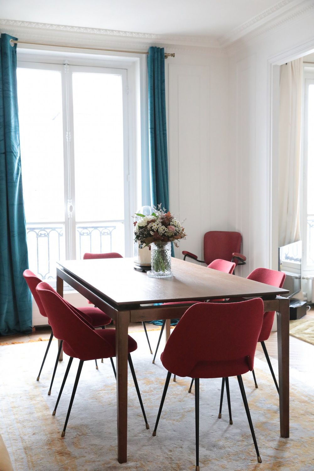 Parisian dining room with Turquoise curtains and pink chairs via Hello-hello Camille Omerin