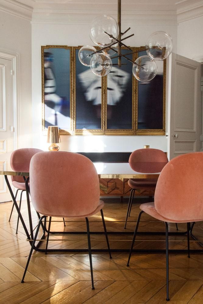 Parisian dining room with mid-century glass ball chandelier and pink dining chairs via The Socialite Family Aroussia Chamakh