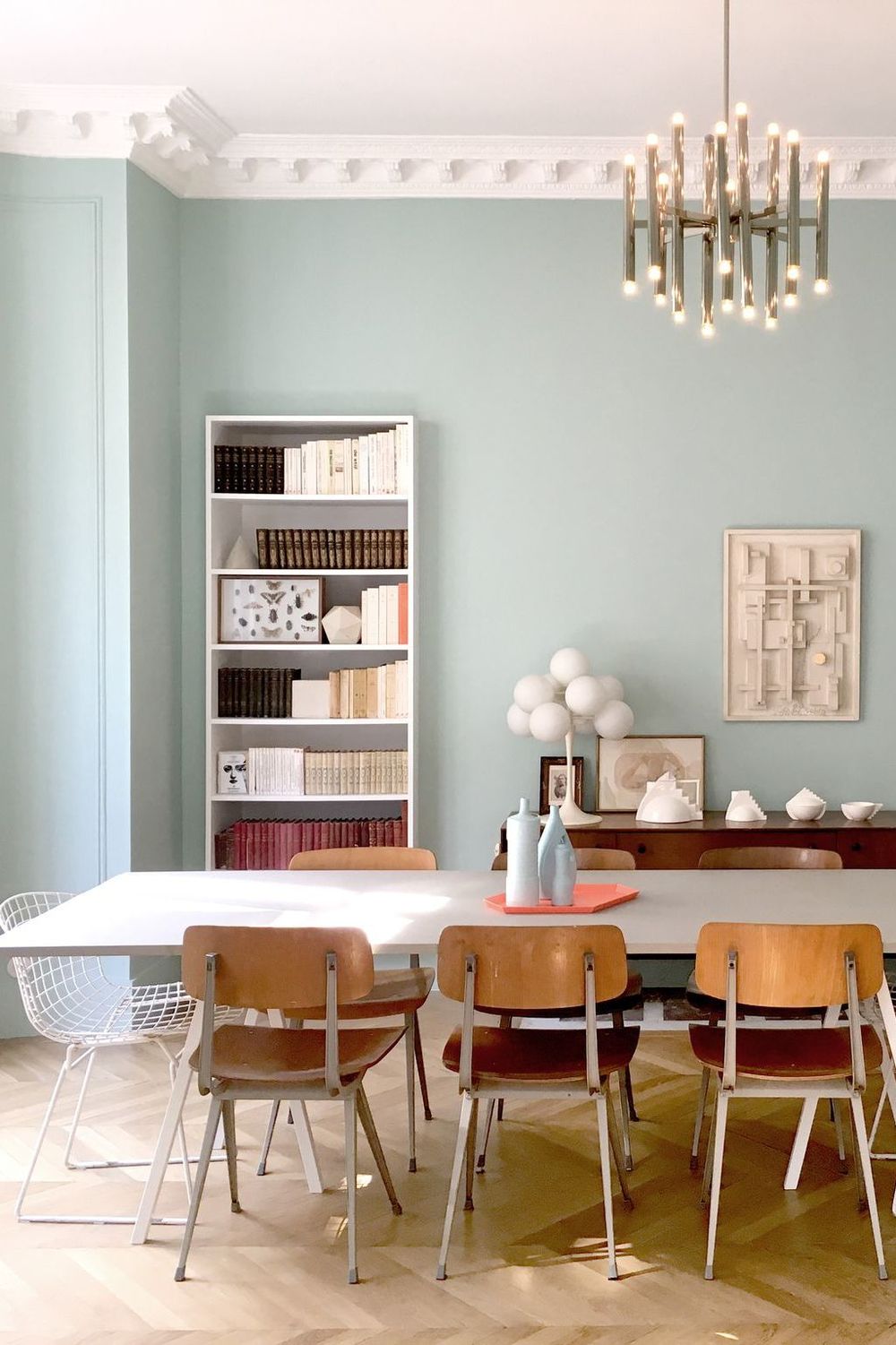 Parisian dining room with mint walls and thrifted dining chairs via CoteMaison DPLG Suzanne Tanascaux