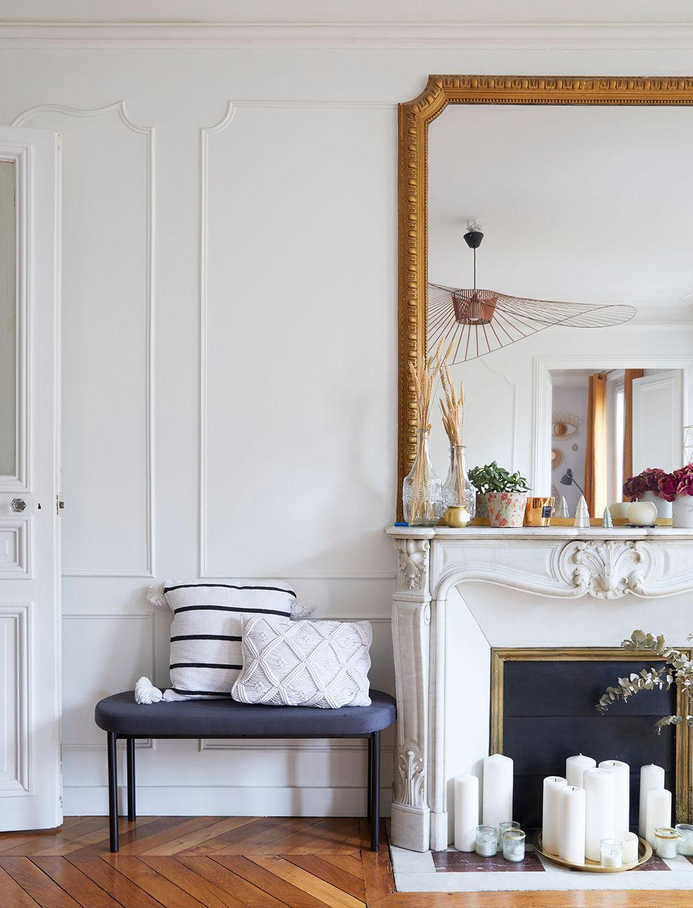 Parisian fireplace decor with White candles in front of opening via Cup of Jo