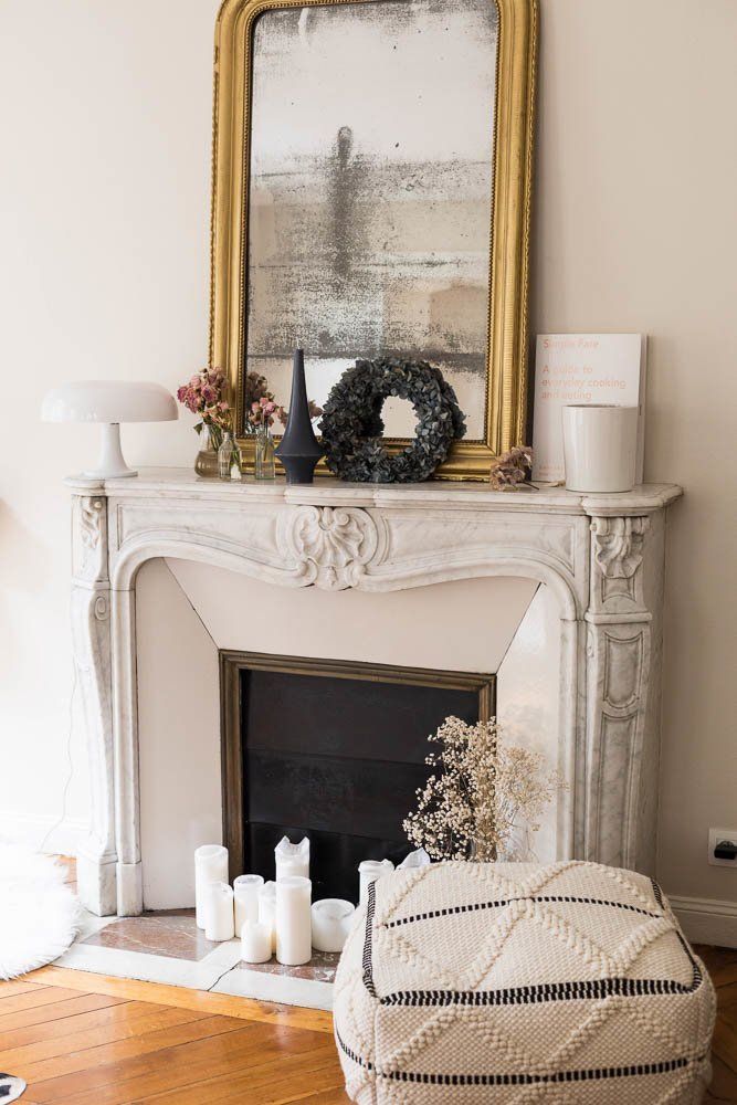 Parisian fireplace with distressed gold mirror via The Socialite Family Audrey Borrego