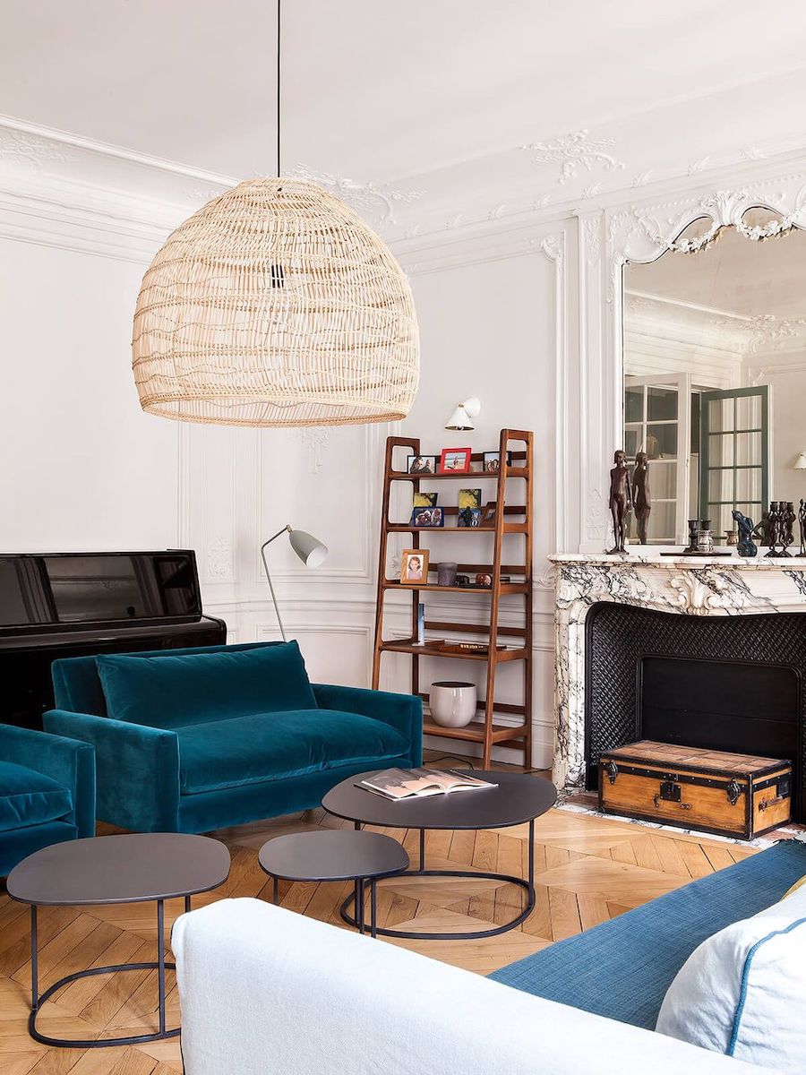 Parisian fireplace with Vintage trunk in living room via Camille Hermand