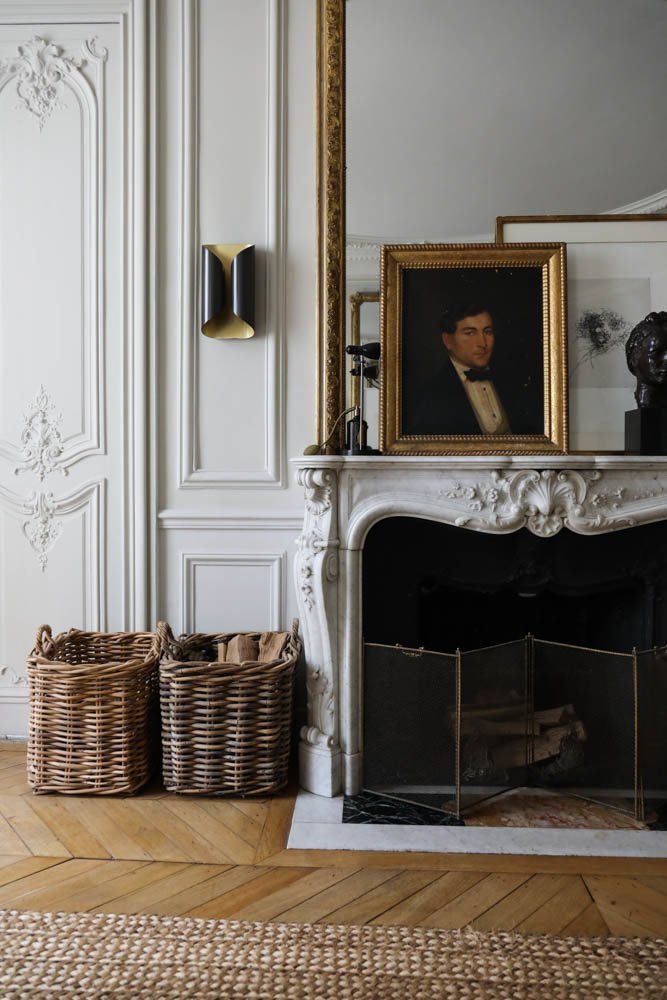 Parisian fireplace with dark Vintage painting via TheSocialiteFamily Dorothee Boissier