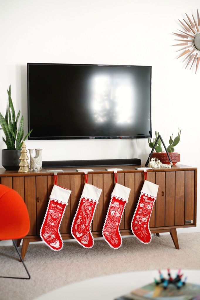 Christmas stockings on a mid-century sideboard via suburbanpop