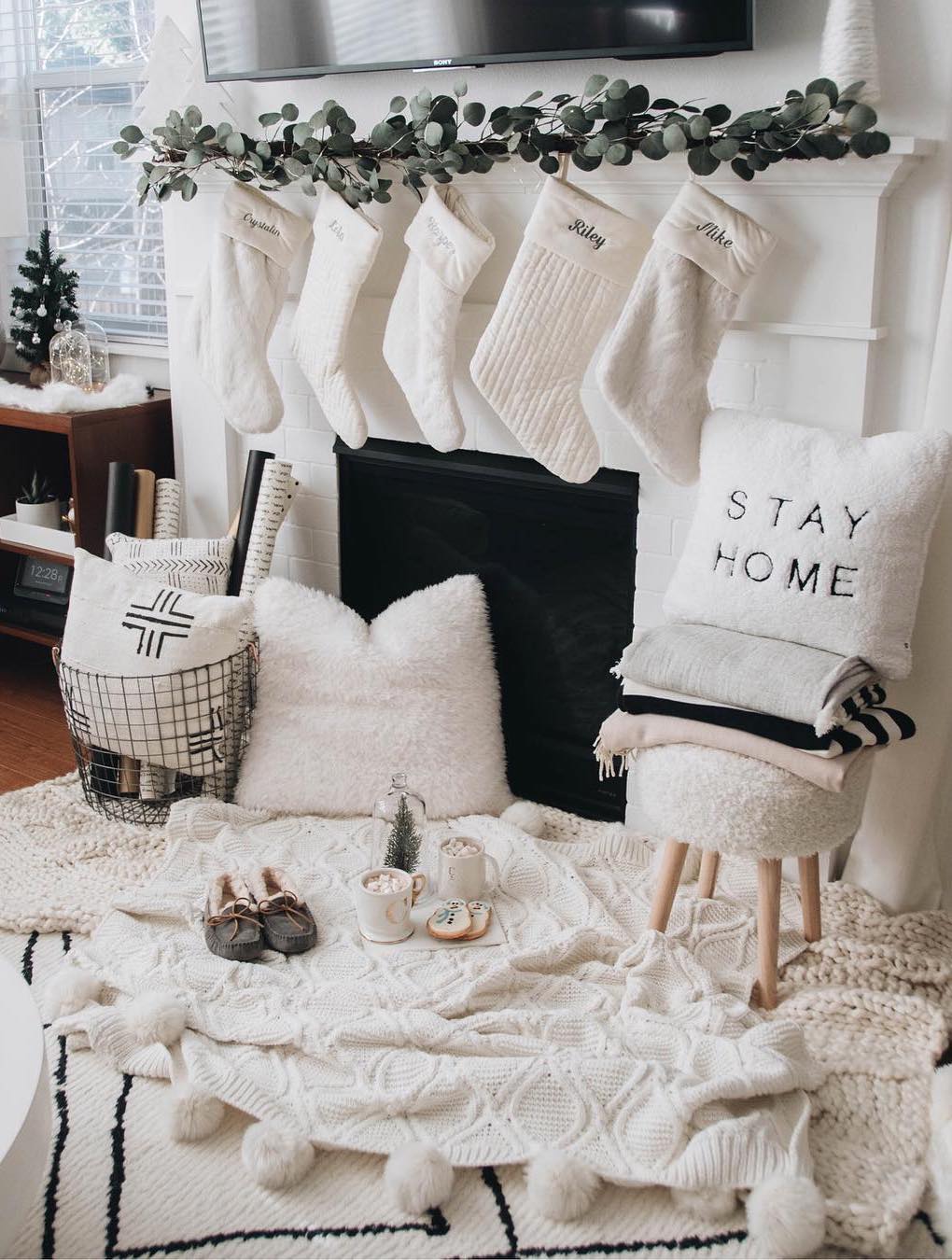 https://curatedinterior.com/wp-content/uploads/2019/11/Cozy-Winter-Home-with-White-Throw-Blankets-Slippers-Stockings-and-a-Fireplace-via-@crystalinmarie.jpg