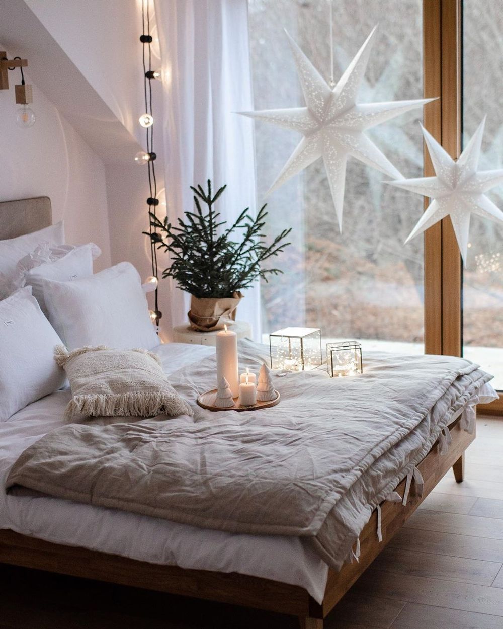 Large white hanging stars in Scandi Christmas Bedroom Decor via @annamichaliszyn