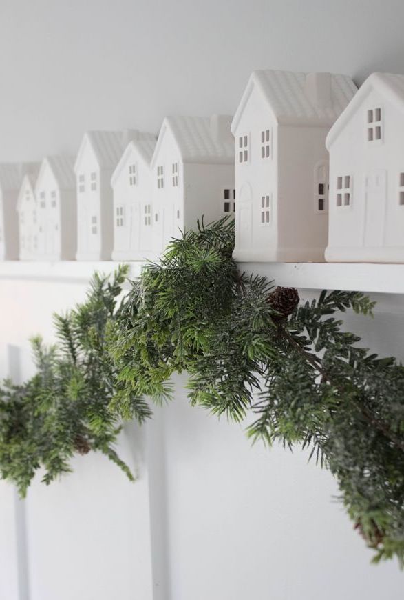 Little white houses on shelf with evergreen via housemixblog