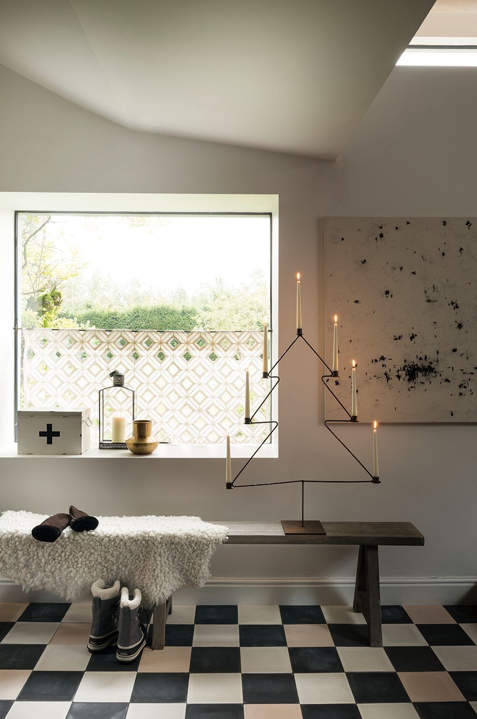 Scandi Christmas Entryway Idea with wire Metal Christmas Tree Frame with Candles and fur throw