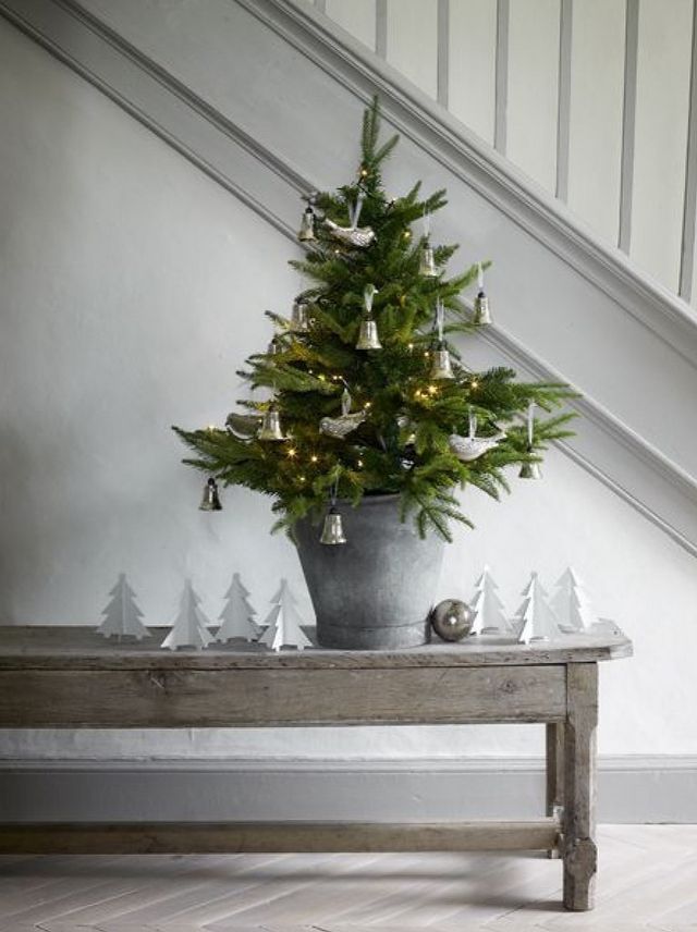 Scandi staircase with wood bench and little white Christmas tree accents
