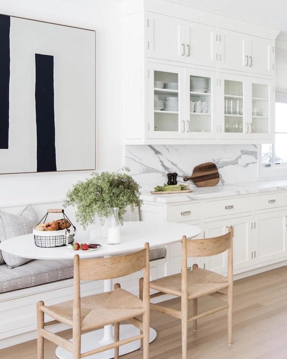 Built-in banquette seating next to the kitchen via Alyssa Kapito Interiors