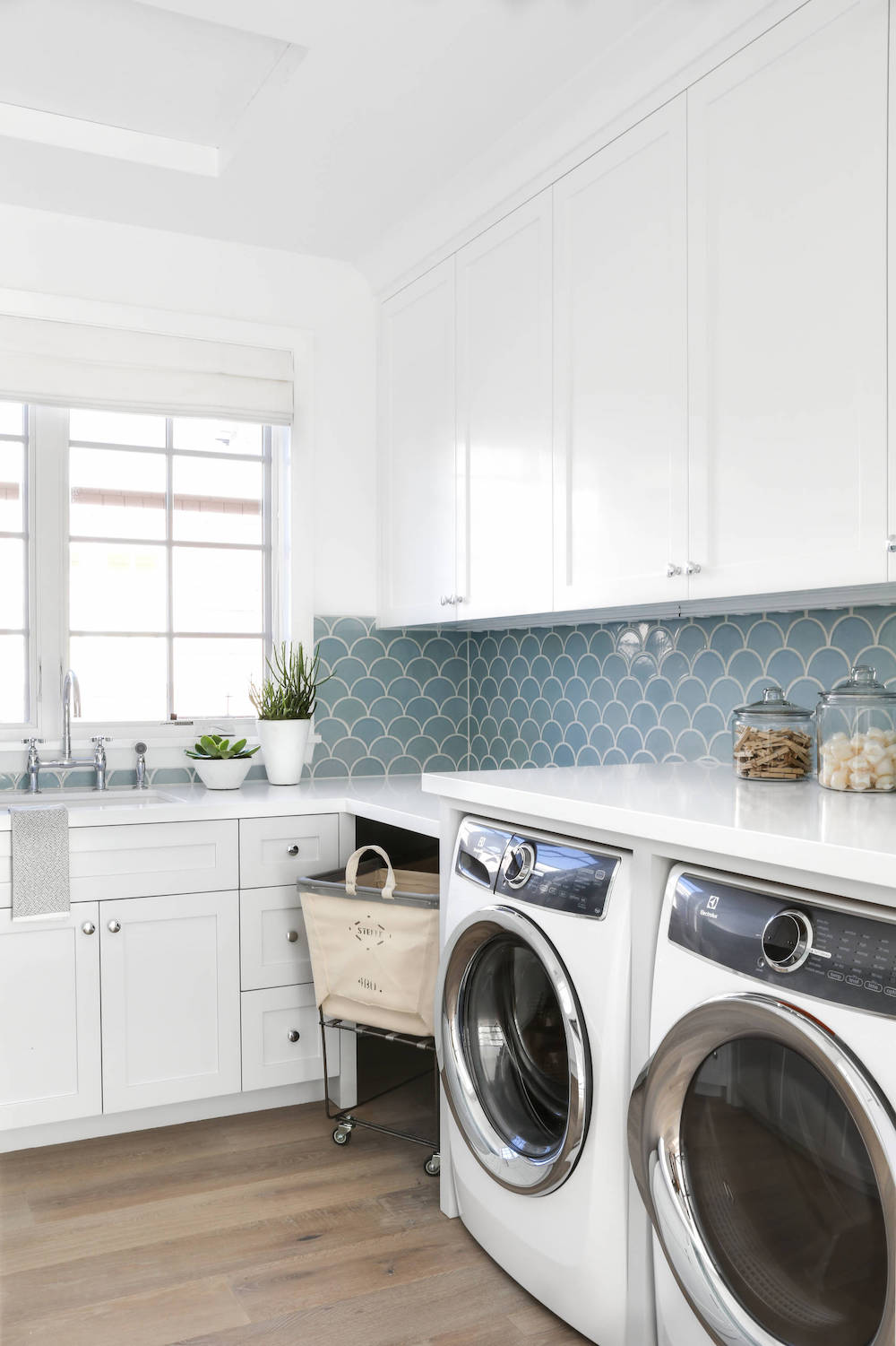 Laundry Room with Blue Tile Backsplash via Lindye Galloway Interiors