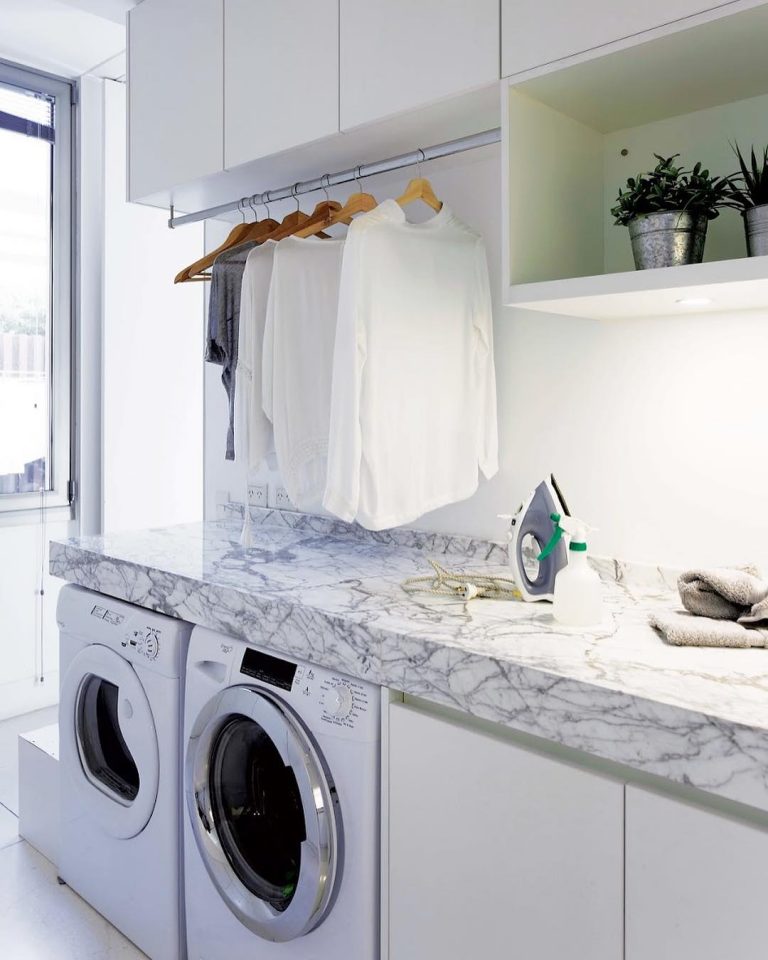 Laundry Room with marble countertops, rod for hanging clothes and cabinets via @revistalivingarg