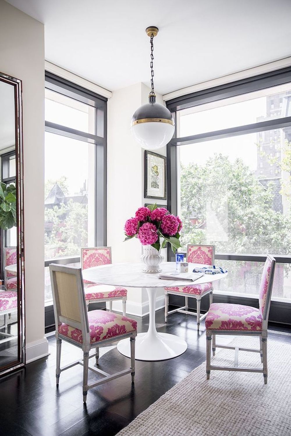 White tulip table with matching pink dining chairs