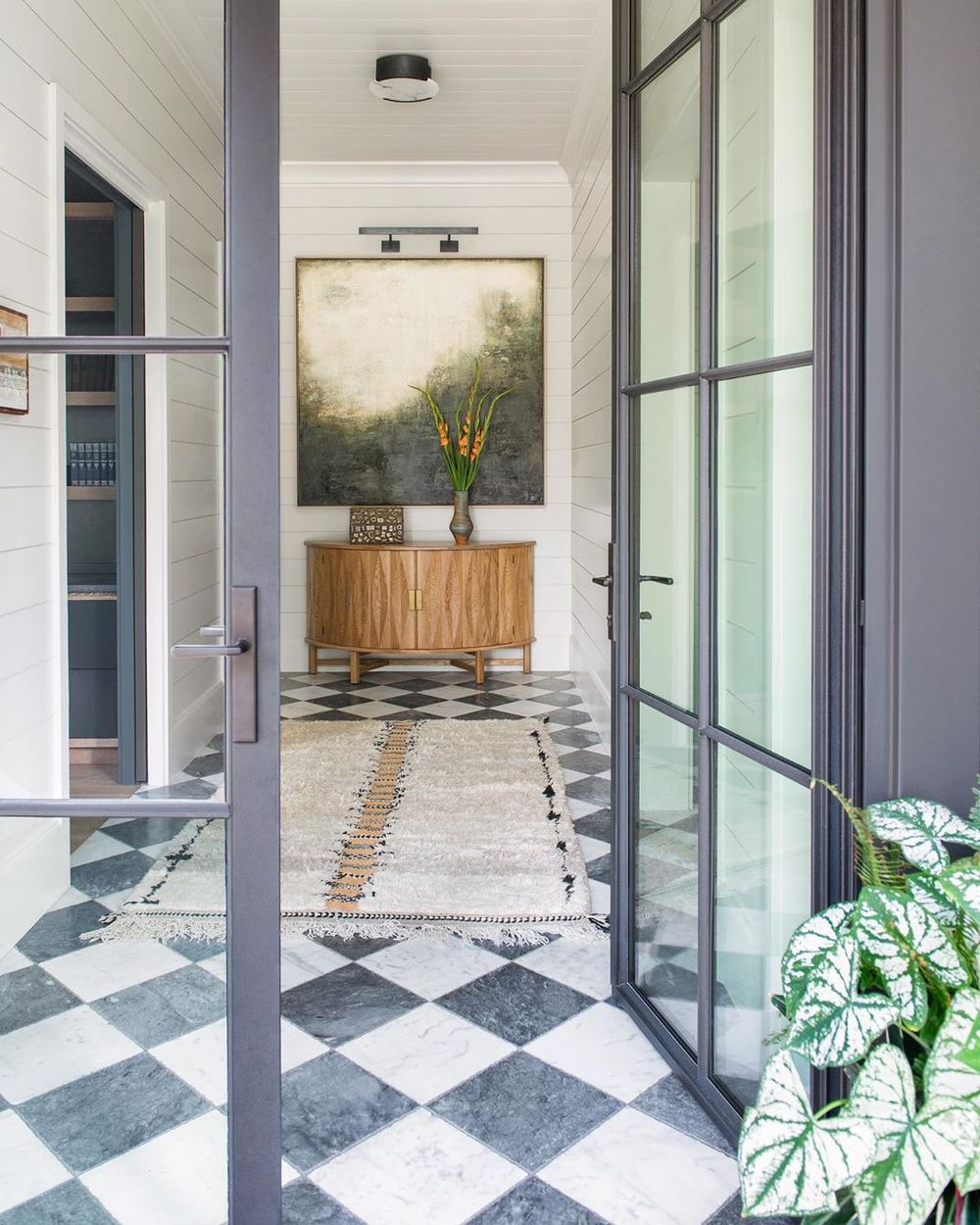 Black and white checkered floor in the entryway via @cortneybishopdesign