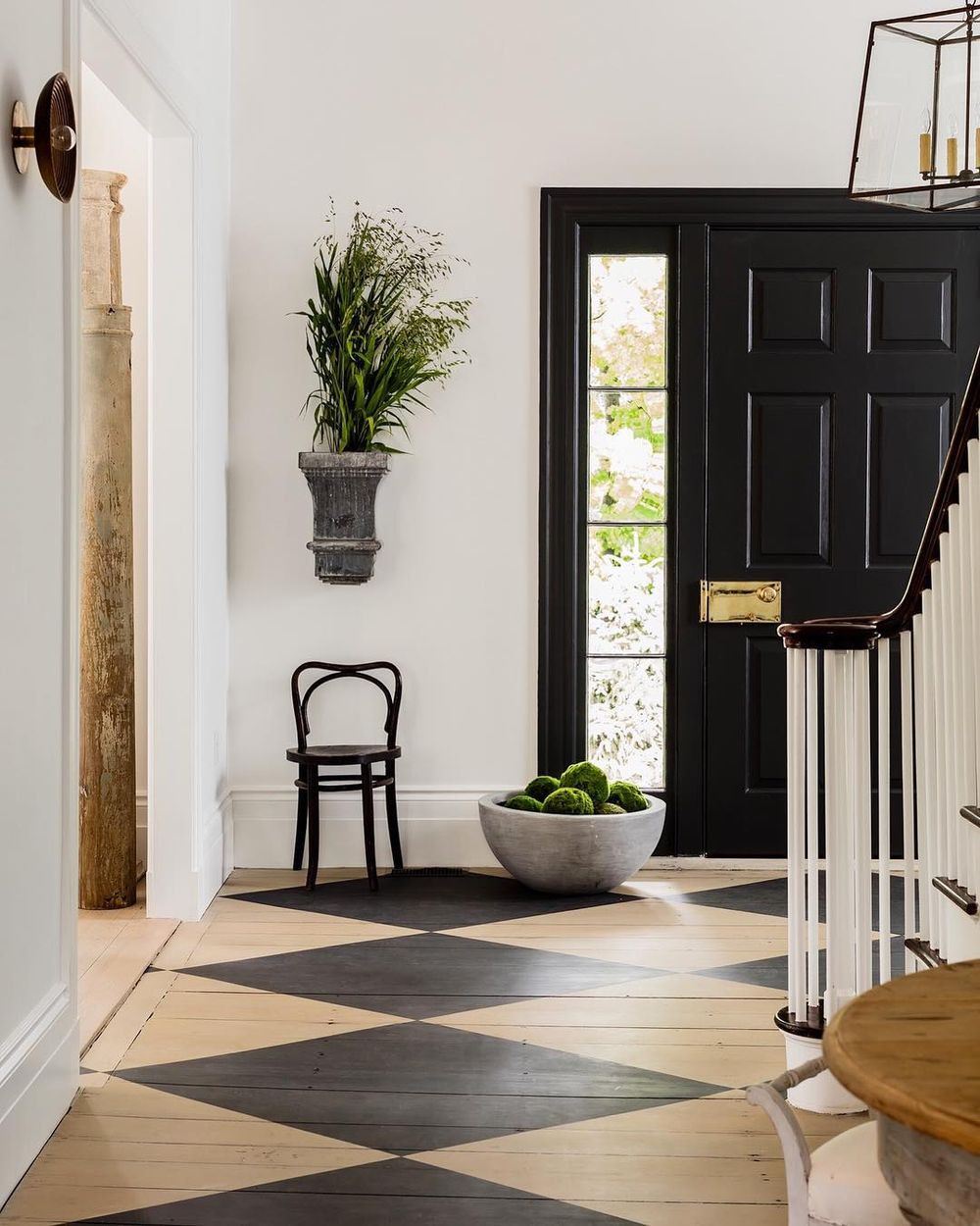 Black and white checkered floor on wood in entryway via @lisa_tharp