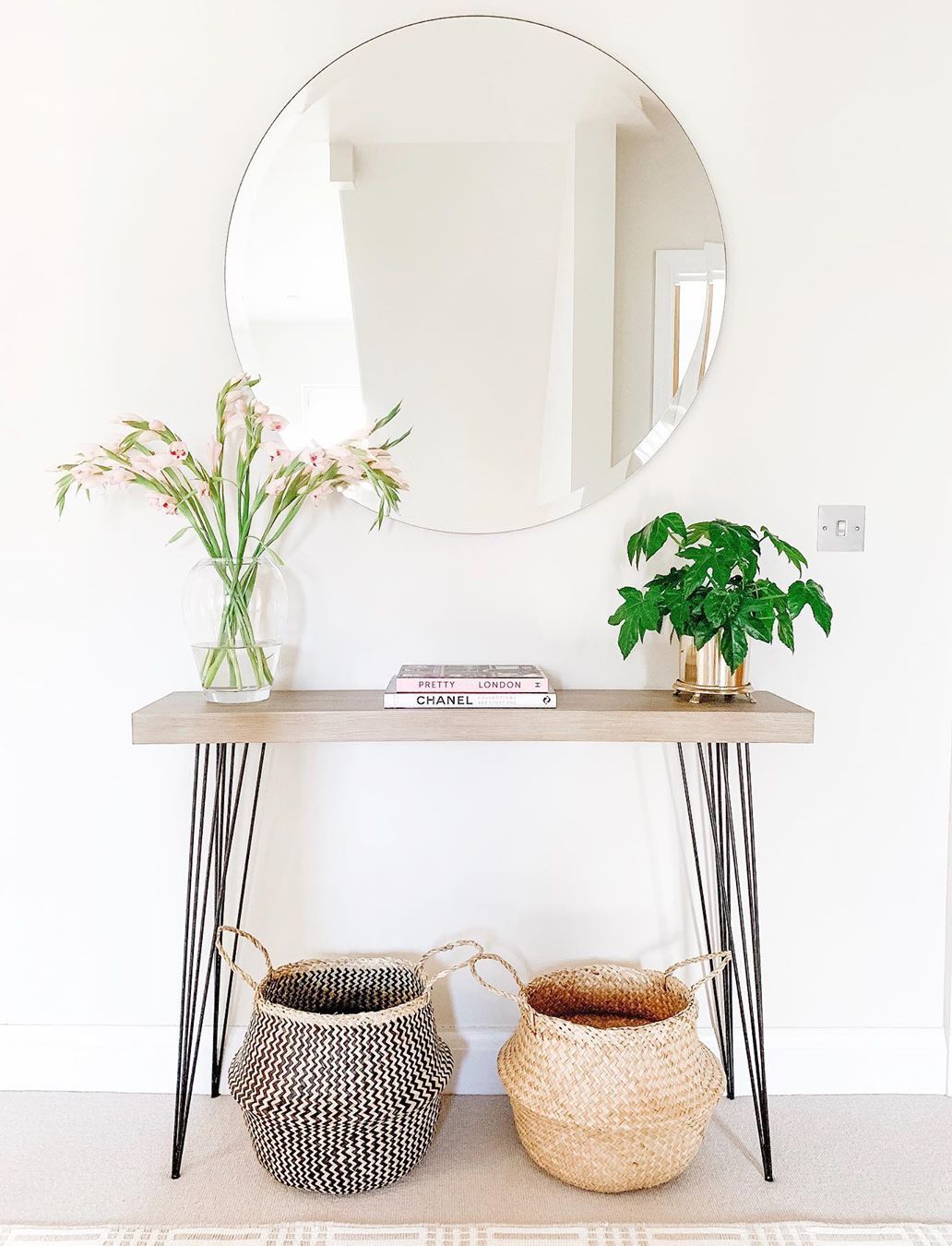 Scandinavian console table with round mirror and wicker baskets via @my_happy_homespace