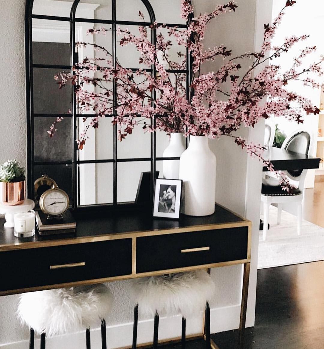 Glam Entryway with Black Console Table and White Faux Fur Stools via @dinachmut