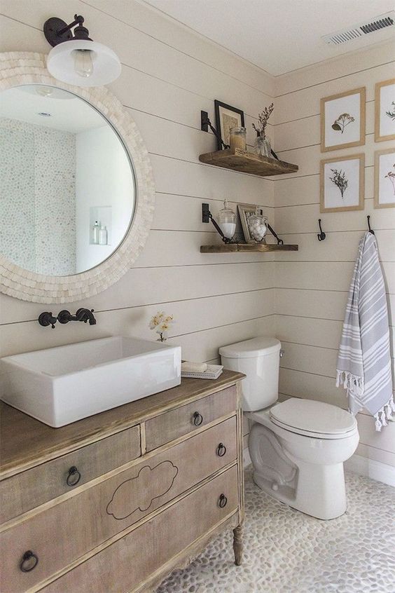 Coastal Bathroom With Beige Shiplap And Pebbled Floors 