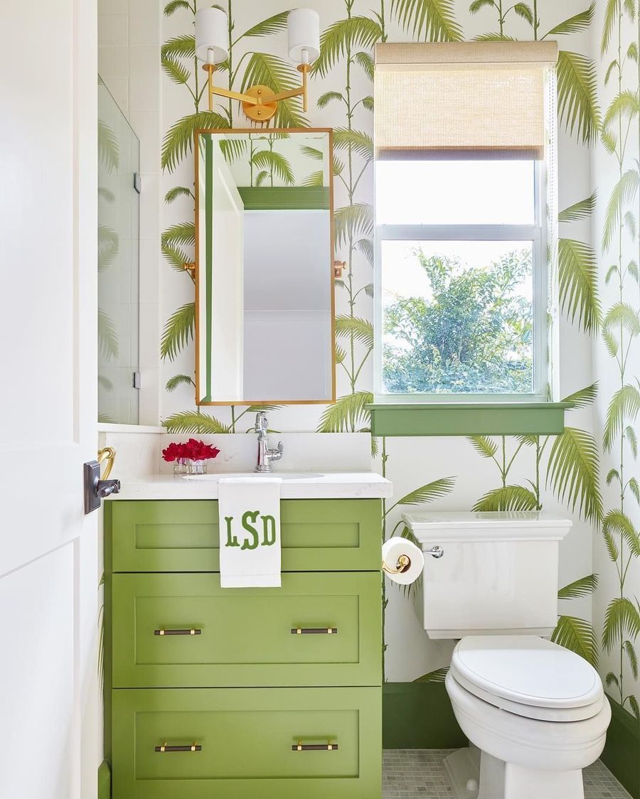 Coastal Bathroom with Green Cabinets and Green Palm Wallpaper via @karahebertinteriors