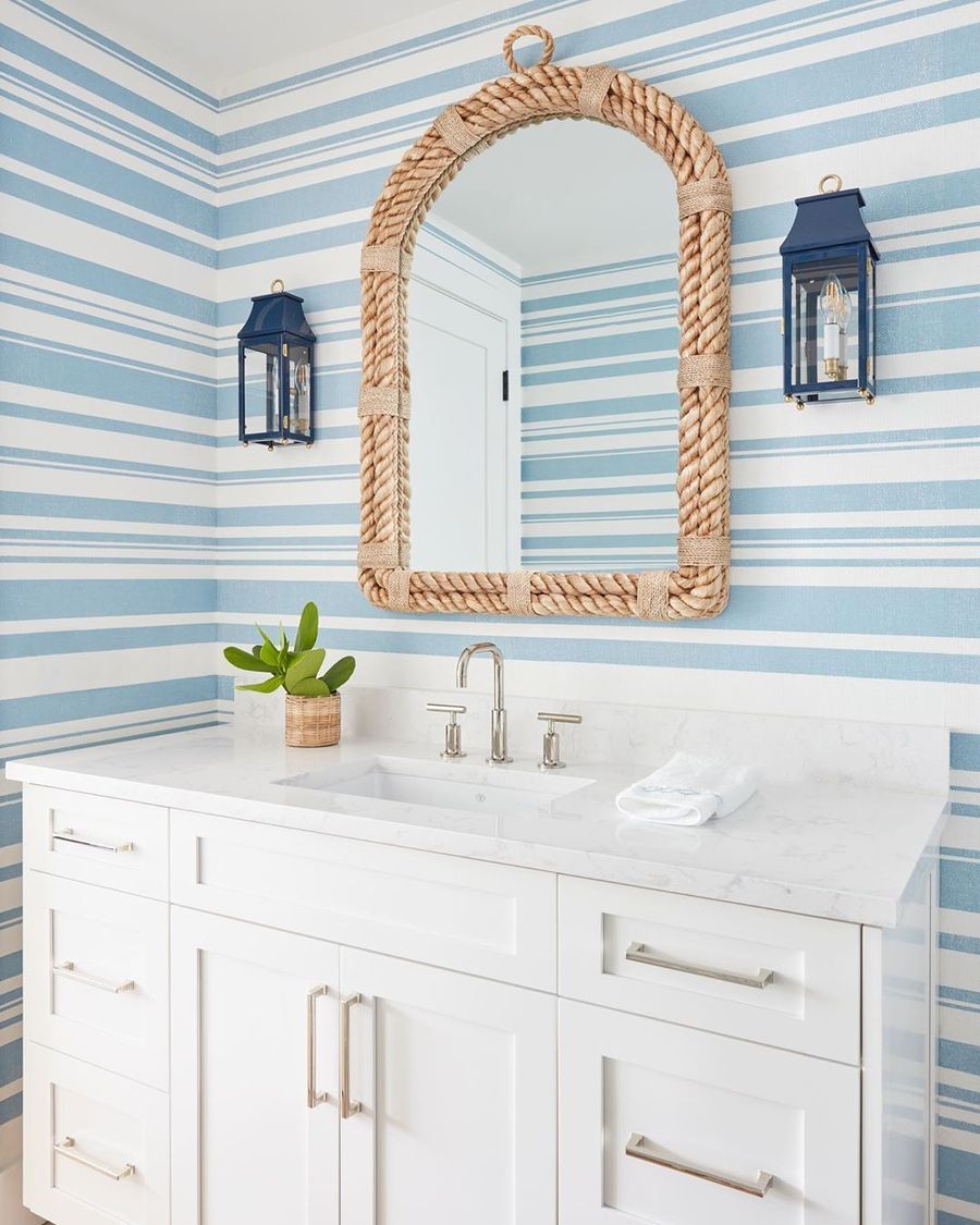 Coastal Bathroom With Rope Mirror And Striped Wallpaper Via @karahebertinteriors  