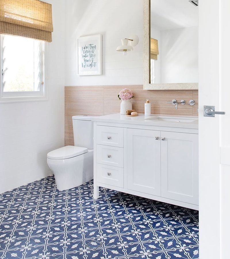 33 Modern Coastal Bathroom Ideas With Beachy Style   Coastal Bathroom With Neutral Panels And Blue Floor Tiles Via @donna Guyler Design 