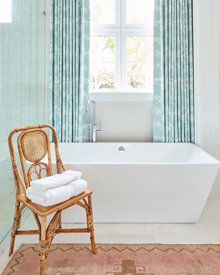 Coastal Bathroom with Rattan chair via @karahebertinteriors