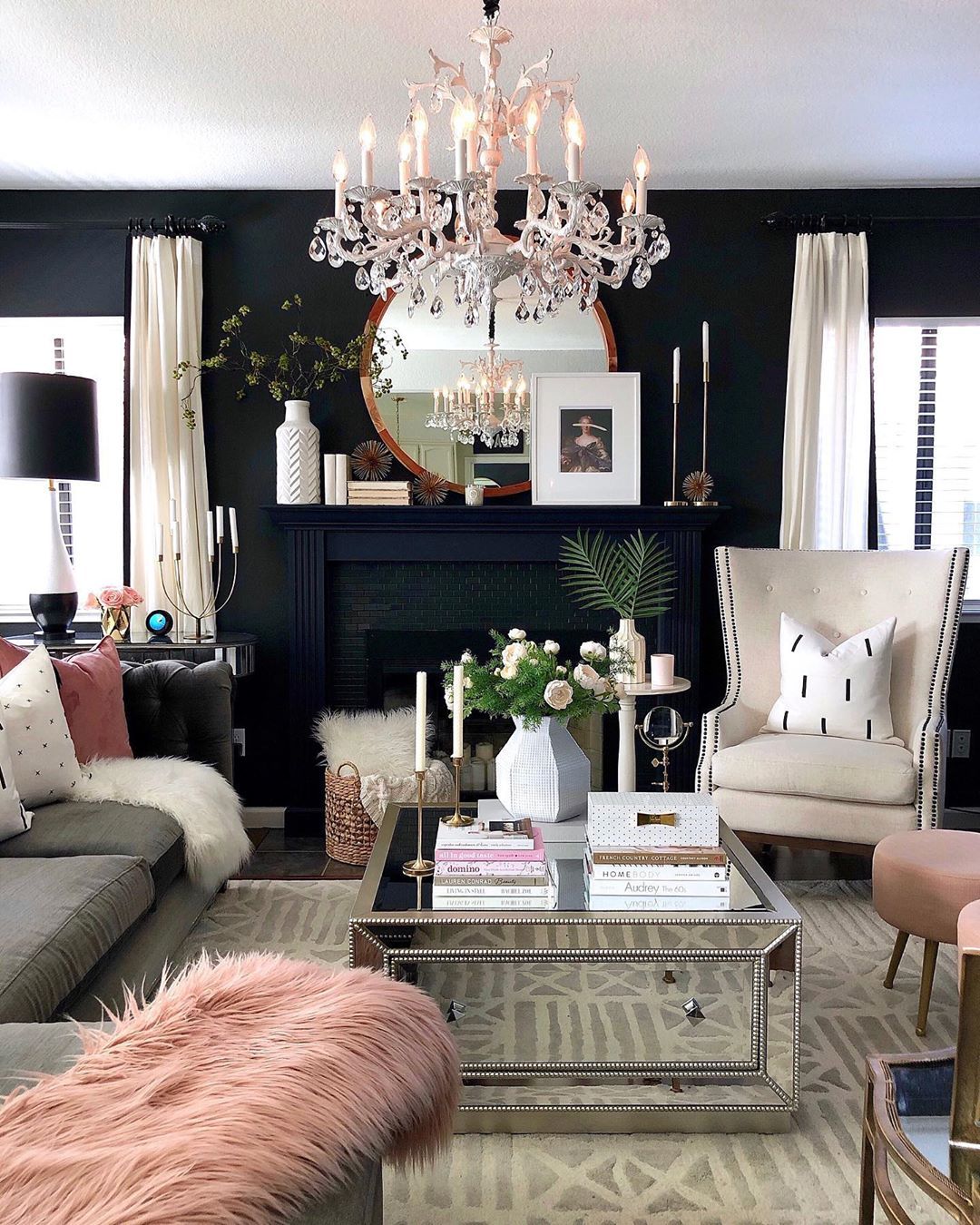 Glam Chandelier above mirrored coffee table in the Living Room via @homeandfabulous