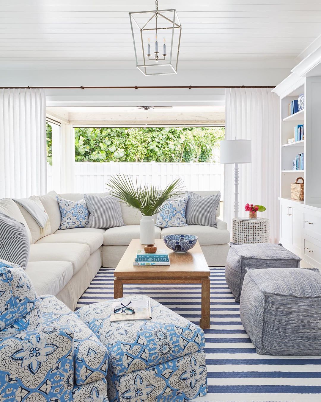 Coastal Living Room with Sectional Sofa and Stripe Rug via @karahebertinteriors