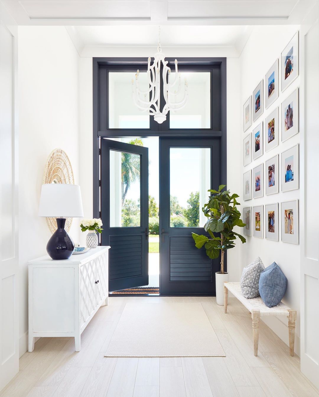 Coastal Entryway with Navy Door via @karahebertinteriors