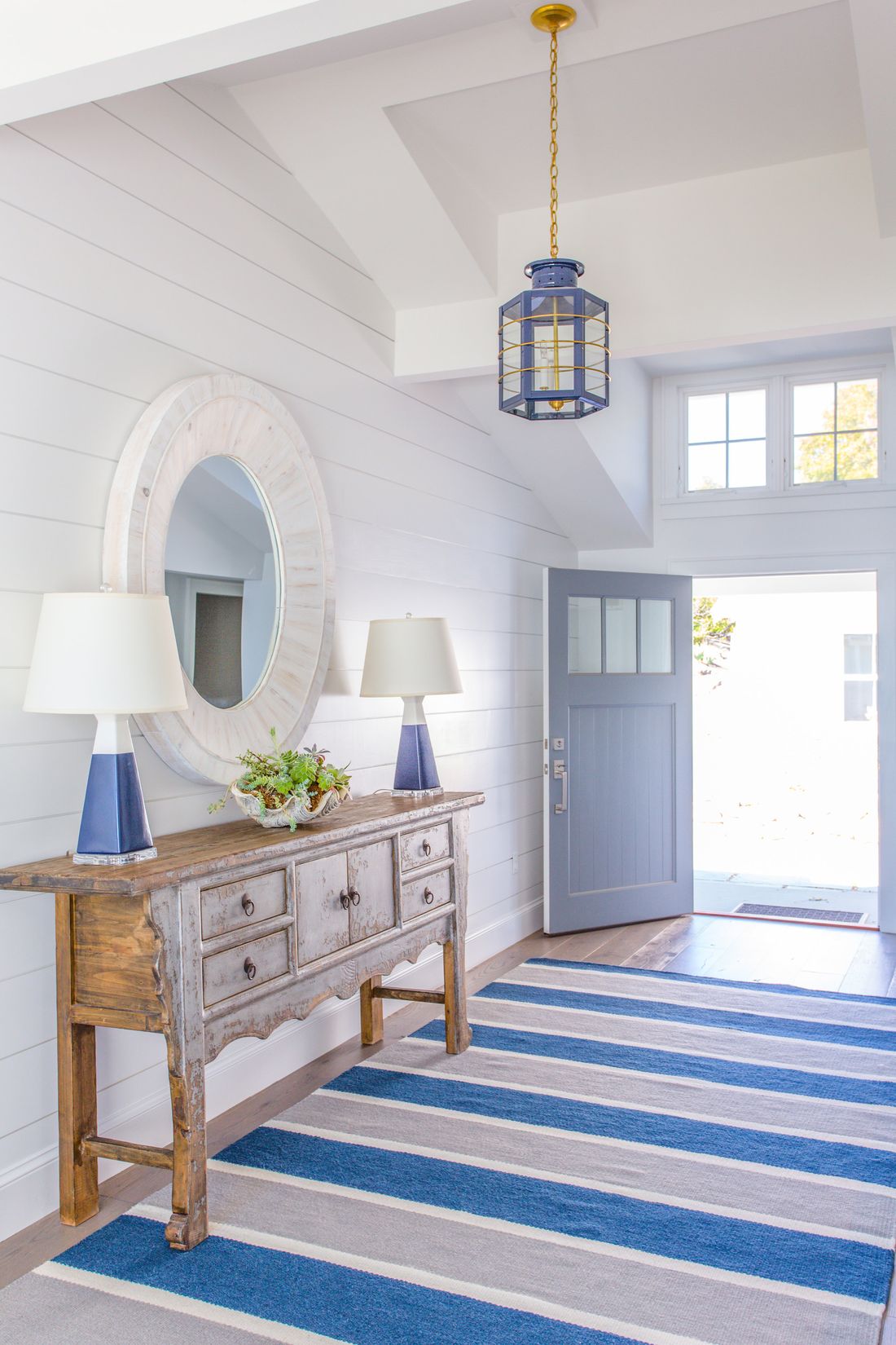 Coastal Entryway with Striped Rug via Molly Frey Design