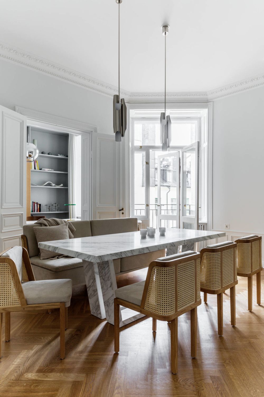 Scandinavian Dining Room with Marble Dining Table and Caneback Chairs via Residence Magazine SE