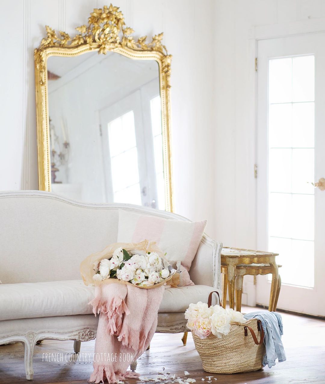French Country Living Room with Vintage Sofa and Gold Leaning Mirror via @frenchcountrycottage