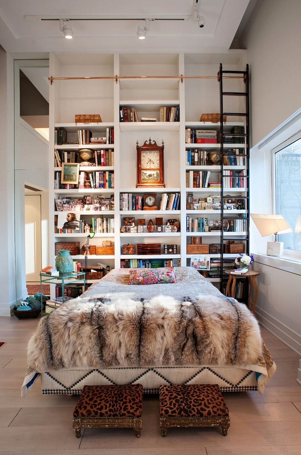 Bedroom with a Sliding Ladder and Tall Bookshelves