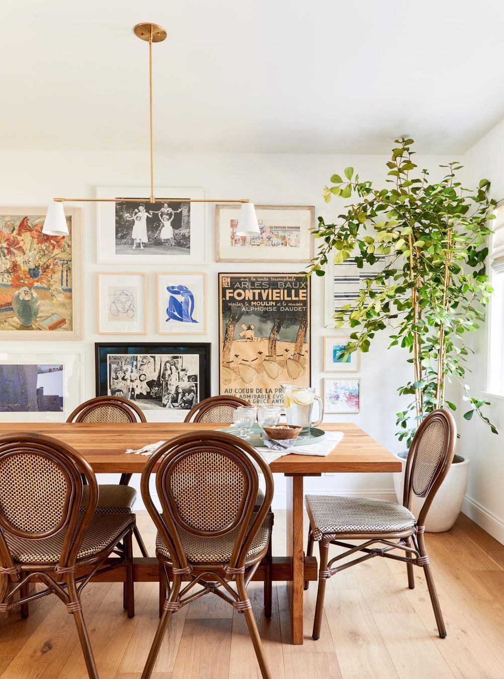 Bohemian Dining Room with Artsy Gallery Wall and Indoor House Tree via @hellosaratrampinteriors