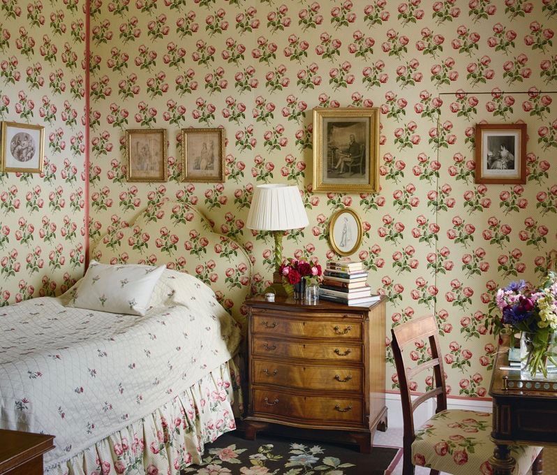 Chintz floral wallpaper, headboard, and bedskirt in English Country Decor Bedroom - Simon Upton House and Garden