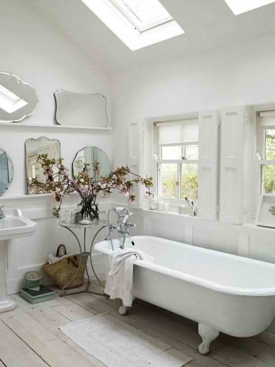 French Country Bathroom with White Clawfoot Tub and Gallery Wall of Mirrors