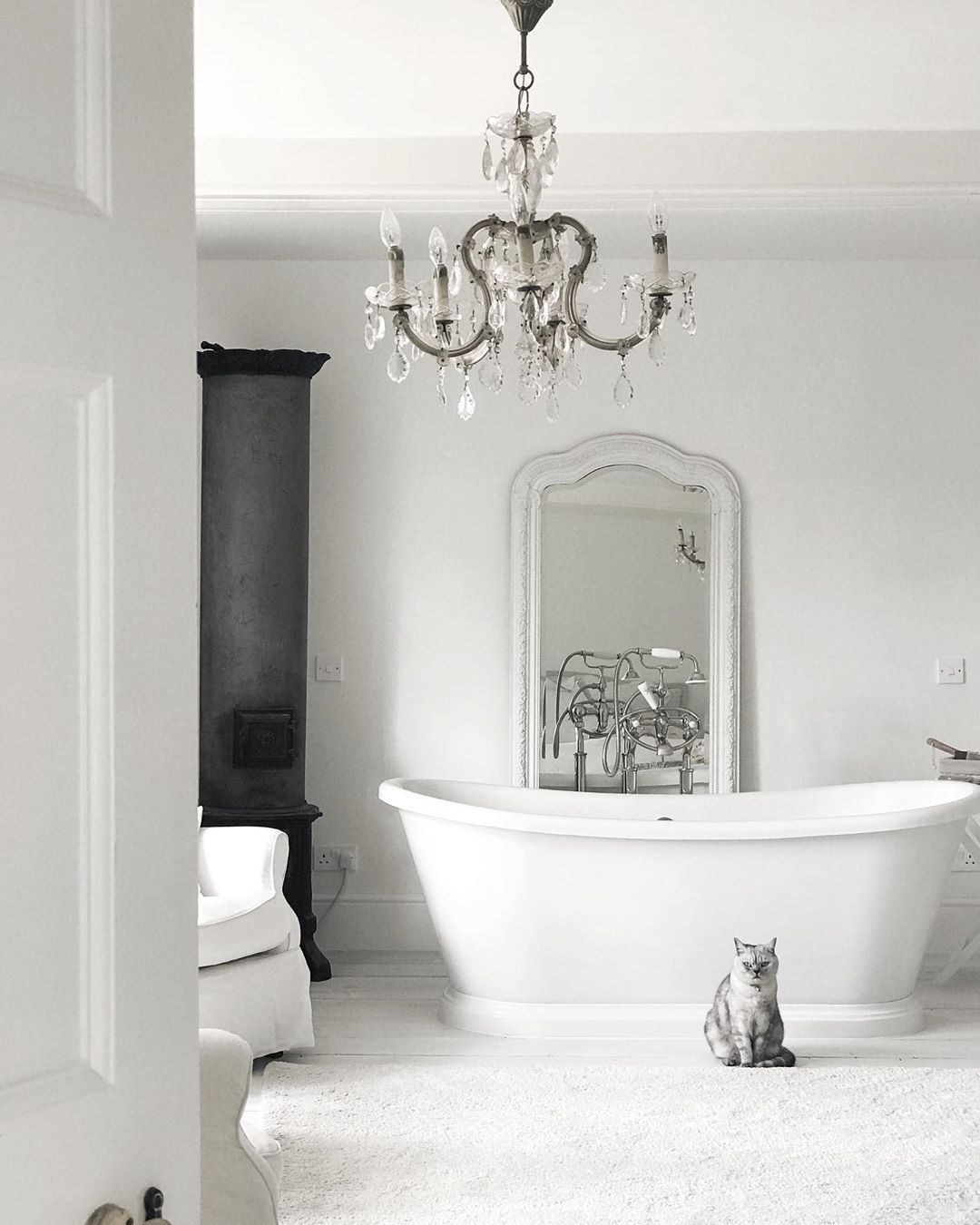French Country Bathroom with White Tub and Crystal Chandelier via @white_and_faded